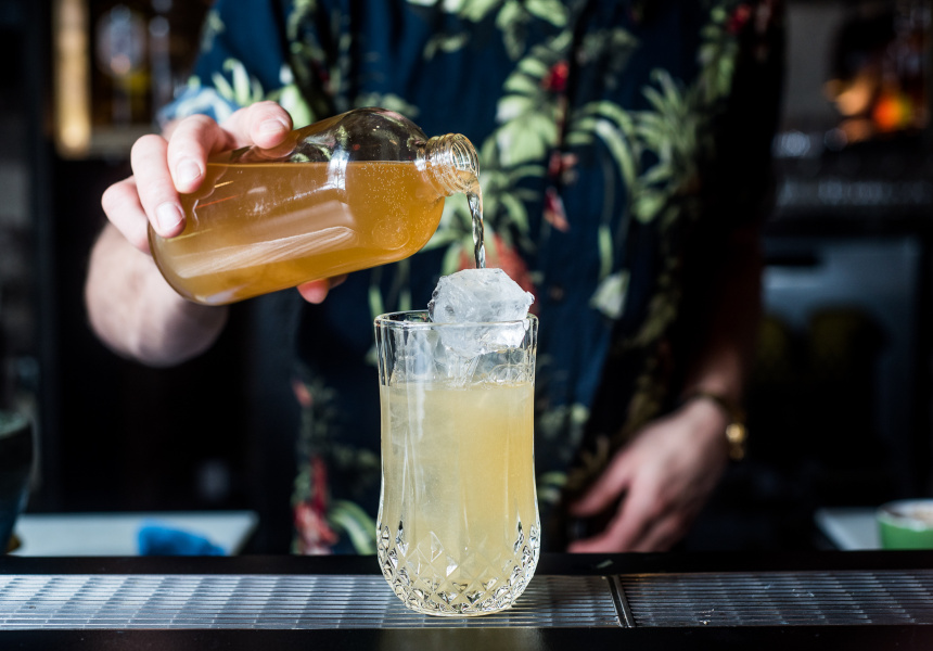 A cocktail is poured into a crystal glass.