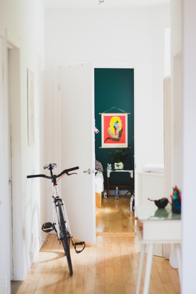 A bike rests against the wall in a home's hallway