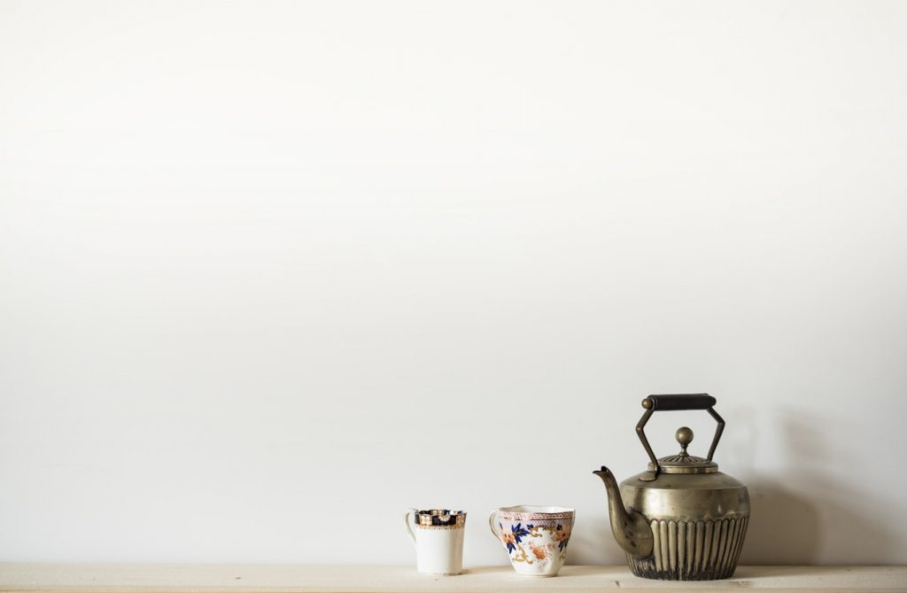 Two teacups and a silver teapot