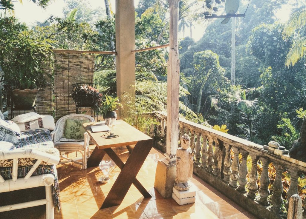 A porch with table and chair overlooking the Ubud jungle
