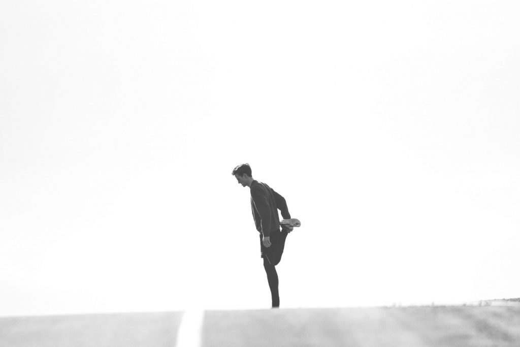 A man is stretching before a run