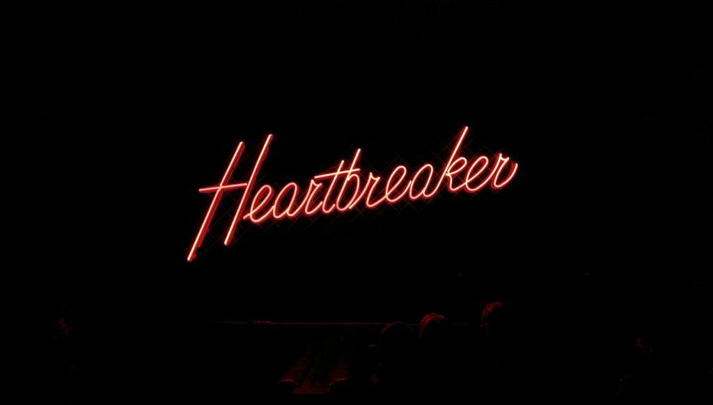 A neon sign reading Heartbreaker