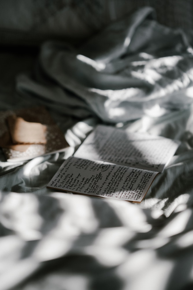 An open journal on a bed