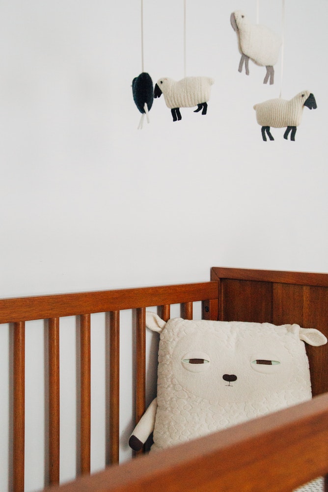 A mobile and crib in a baby nursery